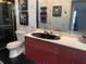 Modern bathroom with a black sink, stylish fixtures, and decorative wallpaper at 2155 Palm View Dr, Apopka, FL 32712