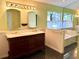 Bathroom features a double vanity with marble countertop, classic fixtures, and a soaking tub with natural light at 2155 Palm View Dr, Apopka, FL 32712