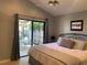 Bright bedroom with patio access featuring tile floors and slider doors to the outdoor patio at 2155 Palm View Dr, Apopka, FL 32712