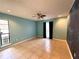 Spacious bedroom with tile floors, ceiling fan, and ample natural light at 2155 Palm View Dr, Apopka, FL 32712