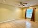 Bedroom with tile floors, ceiling fan, and a large window at 2155 Palm View Dr, Apopka, FL 32712