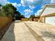 Long paved driveway leading to a house and garage, and lined with a brown wood fence at 2155 Palm View Dr, Apopka, FL 32712