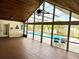 Open lanai with a vaulted ceiling, tile flooring, and a clear view of the inviting backyard pool at 2155 Palm View Dr, Apopka, FL 32712