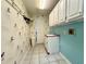 Functional laundry room with sink, cabinets, and tiled floor at 2155 Palm View Dr, Apopka, FL 32712