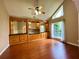 Open living room with hardwood floors, large window, and built-in shelves at 2155 Palm View Dr, Apopka, FL 32712