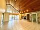Spacious living room with vaulted ceilings, tile flooring, and a stone fireplace at 2155 Palm View Dr, Apopka, FL 32712
