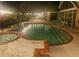 The lit pool and spa create a magical evening ambiance for relaxation and enjoyment at 2155 Palm View Dr, Apopka, FL 32712