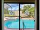 Backyard pool featuring a jacuzzi, screened enclosure, and palm tree landscape at 2155 Palm View Dr, Apopka, FL 32712