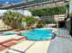 Refreshing pool and spa area with a screened enclosure, palm trees, and ample patio space at 2155 Palm View Dr, Apopka, FL 32712