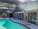 A screened-in pool features a sun shelf and integrated spa, creating a private outdoor retreat at 2155 Palm View Dr, Apopka, FL 32712