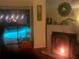 Cozy fireplace provides ambiance with a view of the backyard pool at night at 2155 Palm View Dr, Apopka, FL 32712