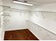 Spacious walk-in closet with custom shelving and wood floors at 2155 Palm View Dr, Apopka, FL 32712
