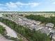 Aerial view showcases a community of homes nestled among lush green trees at 2256 Betsy Ross Ln, St Cloud, FL 34769