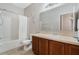 Bathroom featuring a vanity, toilet, and a shower/tub with a white shower curtain at 2256 Betsy Ross Ln, St Cloud, FL 34769