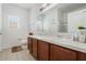Bathroom with dual sinks, a large mirror, and modern fixtures for a functional design at 2256 Betsy Ross Ln, St Cloud, FL 34769