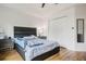 Bedroom with hardwood floors, a dark padded headboard, and ample closet space for storage at 2256 Betsy Ross Ln, St Cloud, FL 34769