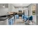 Modern kitchen featuring white and blue cabinets, stainless steel appliances, and an eat-in table at 2256 Betsy Ross Ln, St Cloud, FL 34769