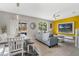 Comfortable living room with a stylish couch, bright yellow accent wall, and outdoor access at 2256 Betsy Ross Ln, St Cloud, FL 34769