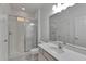 Bright bathroom featuring a tiled shower with glass doors and a vanity with a white countertop at 2311 Victoria Dr, Davenport, FL 33837