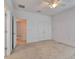 Bright bedroom with neutral carpet, ceiling fan, and closet space at 2311 Victoria Dr, Davenport, FL 33837
