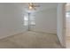 Bright bedroom with neutral carpet, ceiling fan, and windows, offering natural light at 2311 Victoria Dr, Davenport, FL 33837