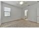Bedroom featuring a window and ceiling fan, neutral carpet and paint creating relaxing space at 2311 Victoria Dr, Davenport, FL 33837