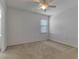 Cozy bedroom featuring neutral carpet, a ceiling fan, and a window, creating a comfortable atmosphere at 2311 Victoria Dr, Davenport, FL 33837