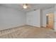 Bright bedroom with neutral carpet, ceiling fan, and white walls, offering a clean and serene space at 2311 Victoria Dr, Davenport, FL 33837