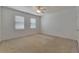 Large bedroom featuring natural light, neutral carpet and paint, and a ceiling fan at 2311 Victoria Dr, Davenport, FL 33837