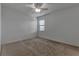 Bedroom featuring neutral carpet and paint, ceiling fan and a window offering natural light at 2311 Victoria Dr, Davenport, FL 33837