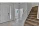 Welcoming entryway featuring a staircase, tile flooring, and a stylish front door with glass pane at 2311 Victoria Dr, Davenport, FL 33837