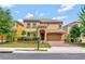 Charming two-story home with a well-maintained lawn, beautiful shrubbery and attached two car garage at 2311 Victoria Dr, Davenport, FL 33837