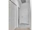 Hallway featuring doors, neutral carpeting and paint, indicating functional layout of home at 2311 Victoria Dr, Davenport, FL 33837