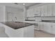 Modern kitchen featuring white cabinets, granite countertops, and a large center island at 2311 Victoria Dr, Davenport, FL 33837