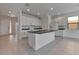Open-concept kitchen featuring granite countertops, white cabinets, and a center island at 2311 Victoria Dr, Davenport, FL 33837