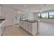 Bright open kitchen with granite countertops, white cabinets, a large island, and tiled floors at 2311 Victoria Dr, Davenport, FL 33837