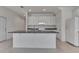 Bright kitchen featuring white cabinets, granite countertops, a center island, and tiled floors at 2311 Victoria Dr, Davenport, FL 33837