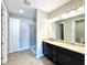 Bathroom with dual sinks, spacious counter, and glass shower, with natural light at 254 Alford Dr, Davenport, FL 33896