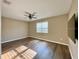 Comfortable bedroom featuring a ceiling fan, wood floors, and a TV for relaxation at 254 Alford Dr, Davenport, FL 33896