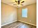 A cozy bedroom featuring wood-look flooring, neutral walls, and ceiling fan at 254 Alford Dr, Davenport, FL 33896
