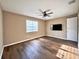 Large, light-filled bedroom with hardwood floors, ceiling fan, and a neutral color scheme at 254 Alford Dr, Davenport, FL 33896