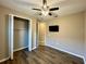 Bedroom with hardwood floors, ceiling fan and TV at 254 Alford Dr, Davenport, FL 33896