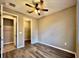 Neutral bedroom with wood-look flooring, fan, and closet at 254 Alford Dr, Davenport, FL 33896