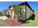 Well-maintained exterior with colorful flowerbed, offering great curb appeal and a two-car garage at 254 Alford Dr, Davenport, FL 33896