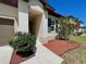 Home with a well-maintained lawn, flowerbed and mature landscaping surrounding the front entrance at 254 Alford Dr, Davenport, FL 33896