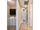 Hallway view including laundry room with washer and dryer and cabinets at 254 Alford Dr, Davenport, FL 33896