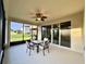 Screened in patio with table and chairs, perfect for enjoying the outdoors at 254 Alford Dr, Davenport, FL 33896