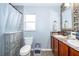 Clean bathroom with double sink vanity, tile accents, and a shower-tub combination at 2602 Adelia Blvd, Deltona, FL 32725