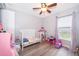 Cozy bedroom with a crib and window, perfect for a room or Bedroom at 2602 Adelia Blvd, Deltona, FL 32725