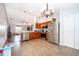 Well-lit kitchen featuring stainless steel appliances, tile flooring, and a view into the living area at 2602 Adelia Blvd, Deltona, FL 32725